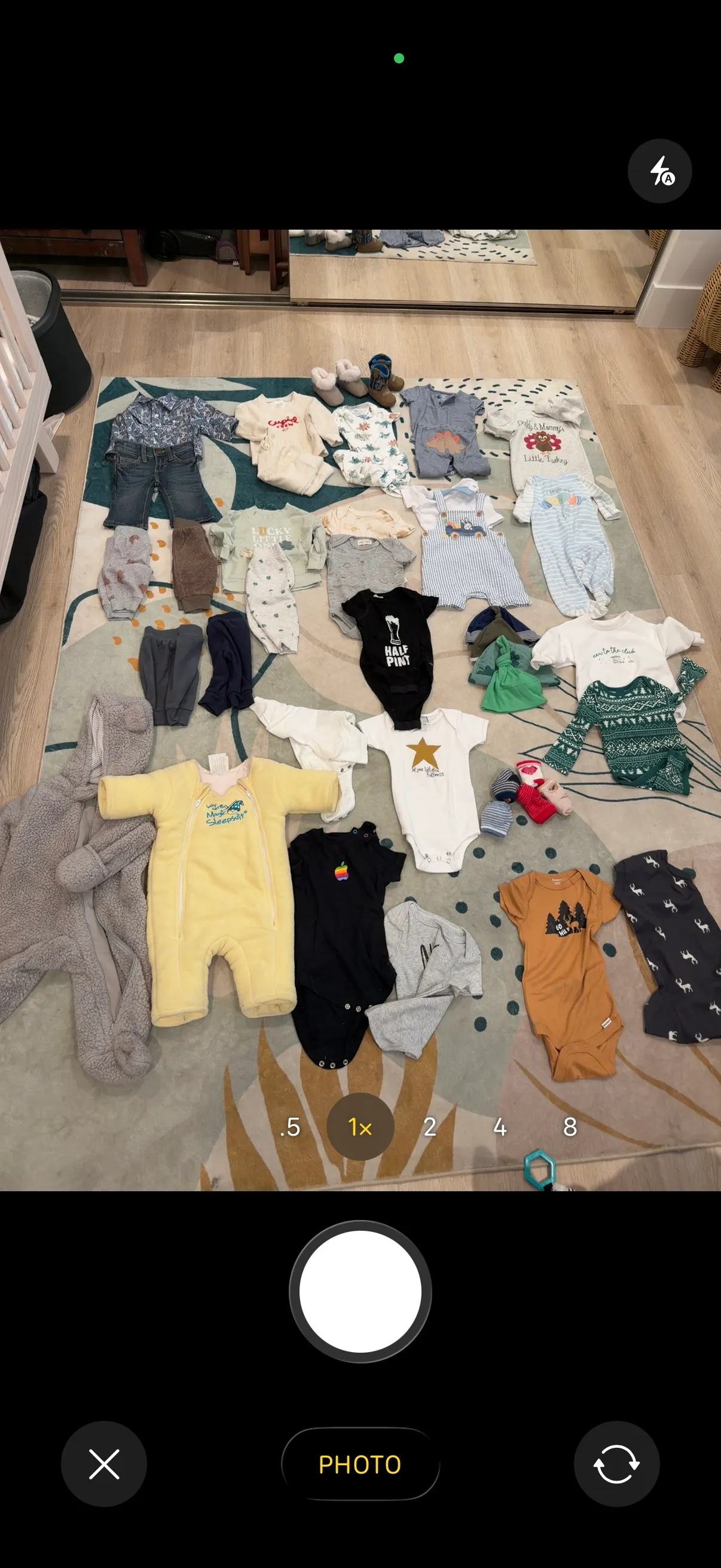 StowQR Itemify on iPhone capturing a tote of baby clothes for AI cataloging