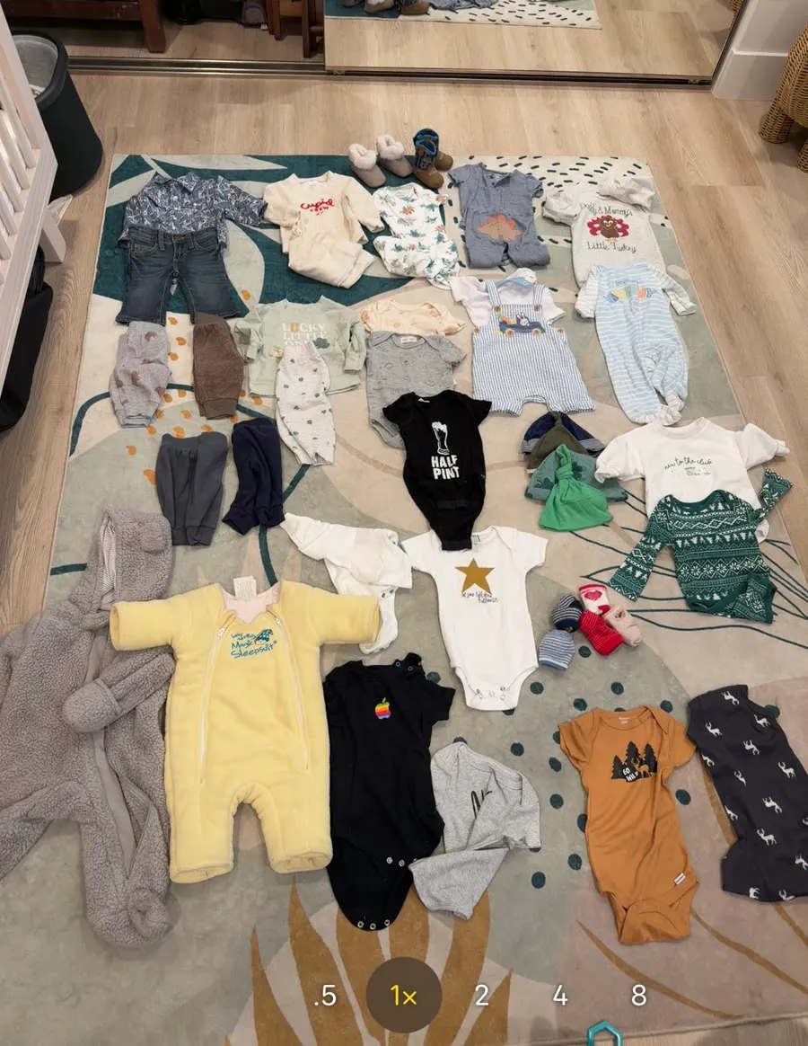Baby clothes laid out on a nursery rug, the photo Itemify catalogs